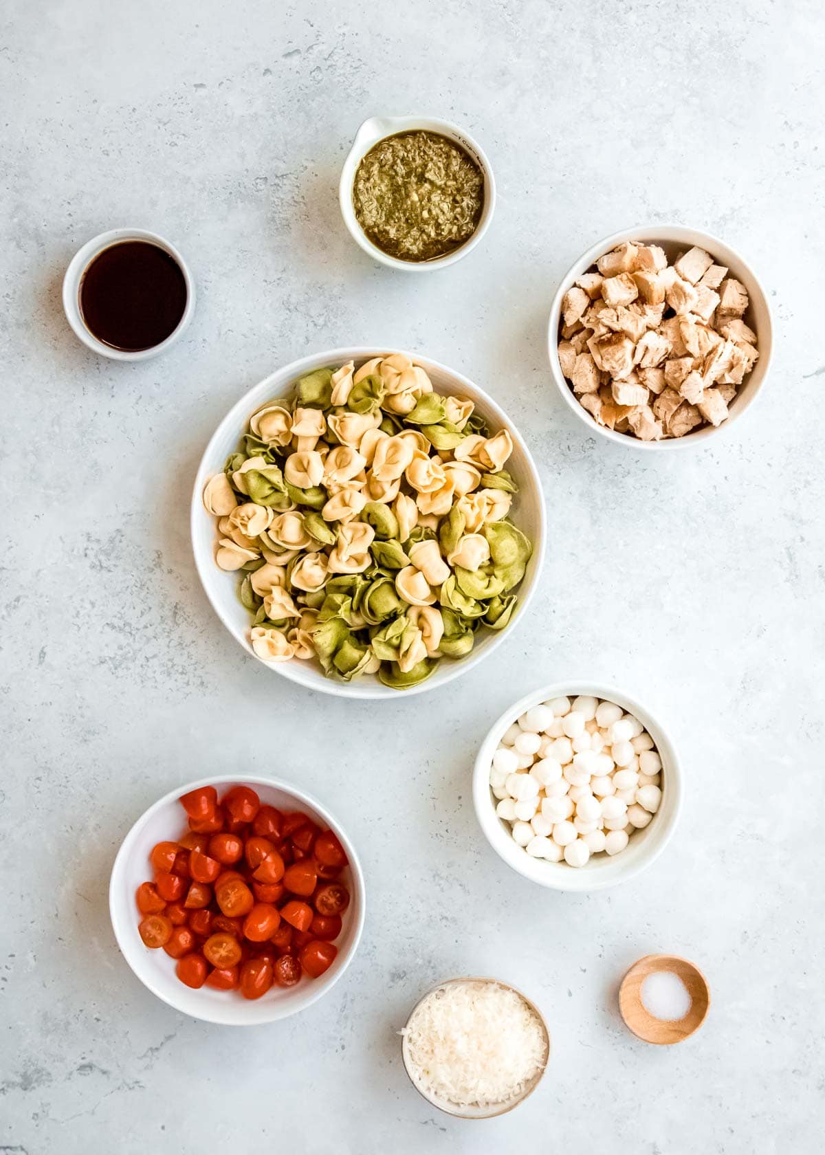 tortellini pasta salad ingredients on a white table