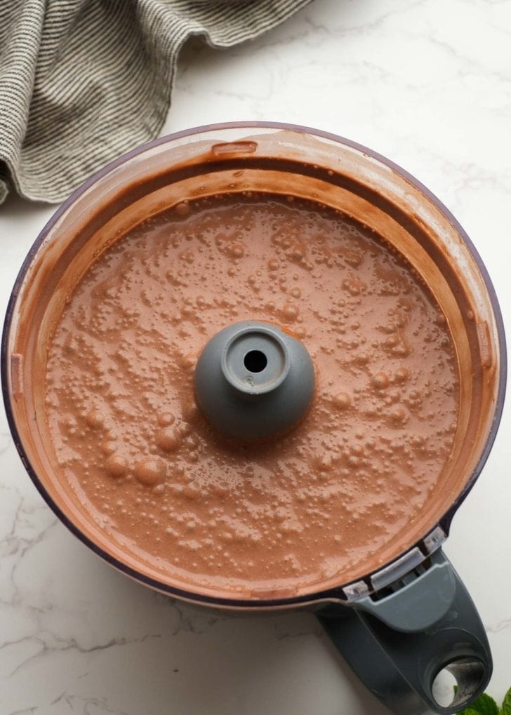 creamy chocolate mint ice cream ingredients mixed together in a food processor