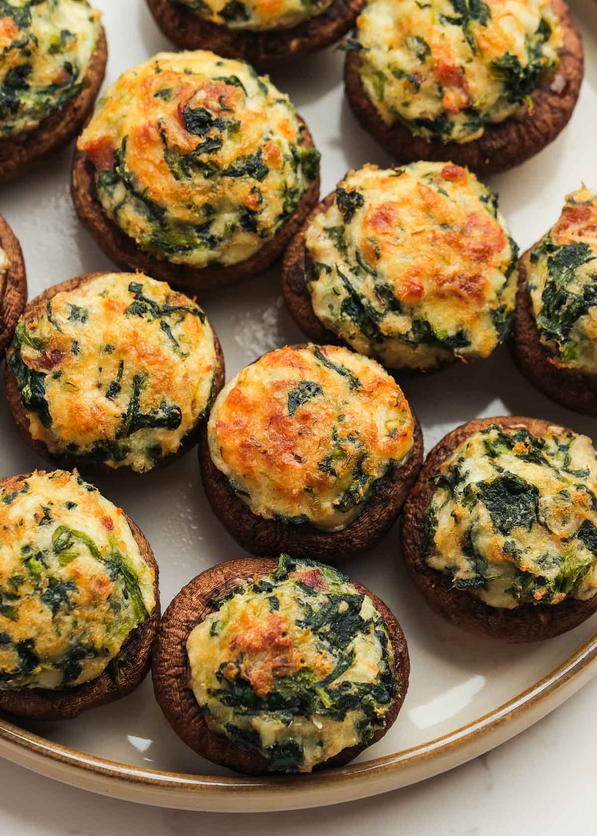 spinach crab and bacon stuffed mushrooms on a platter