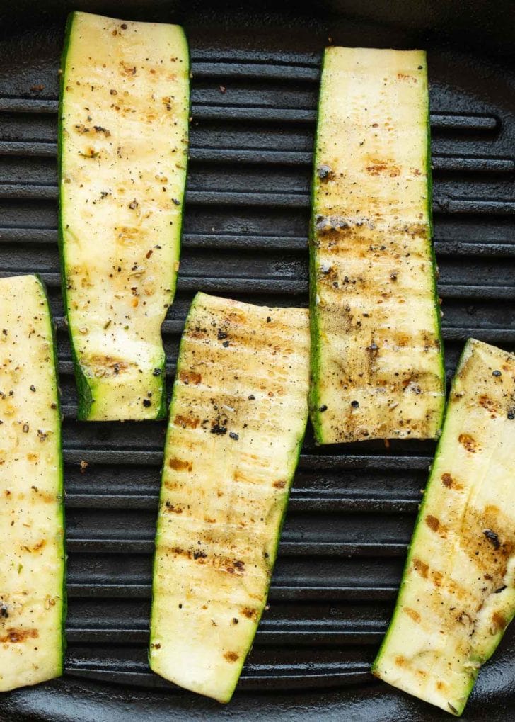 thinly sliced zucchini on a grill 