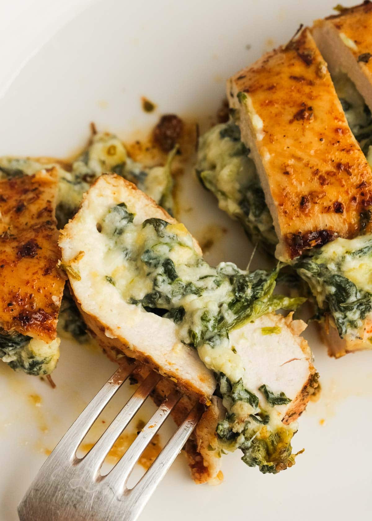 a closeup shot of spinach and cheese stuffed chicken