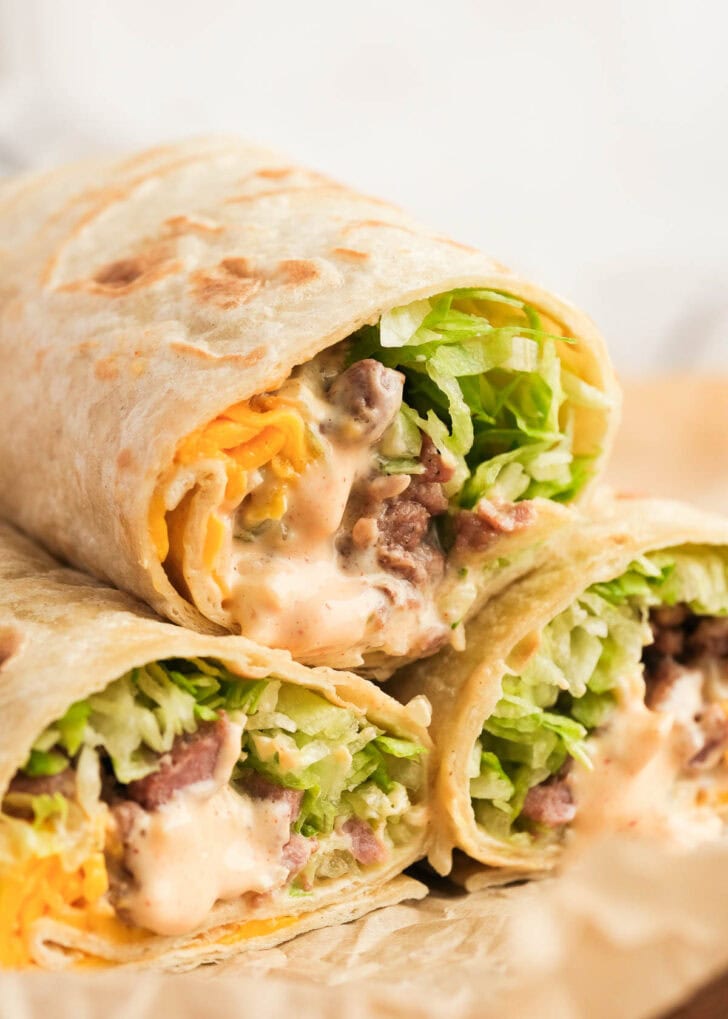 closeup shot of three sliced big mac wraps full of beef, sauce, cheese, and lettuce