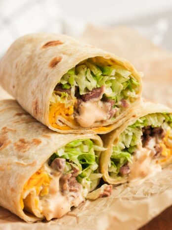 Three Big Mac Wraps stacked on parchment paper