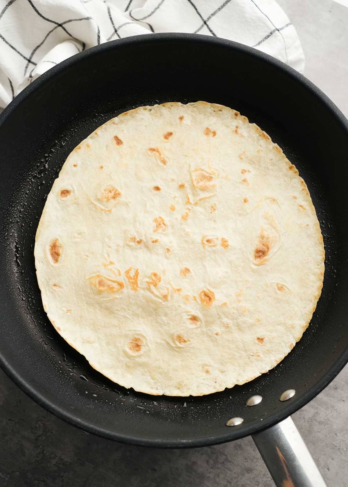 a tortilla browning in a pan