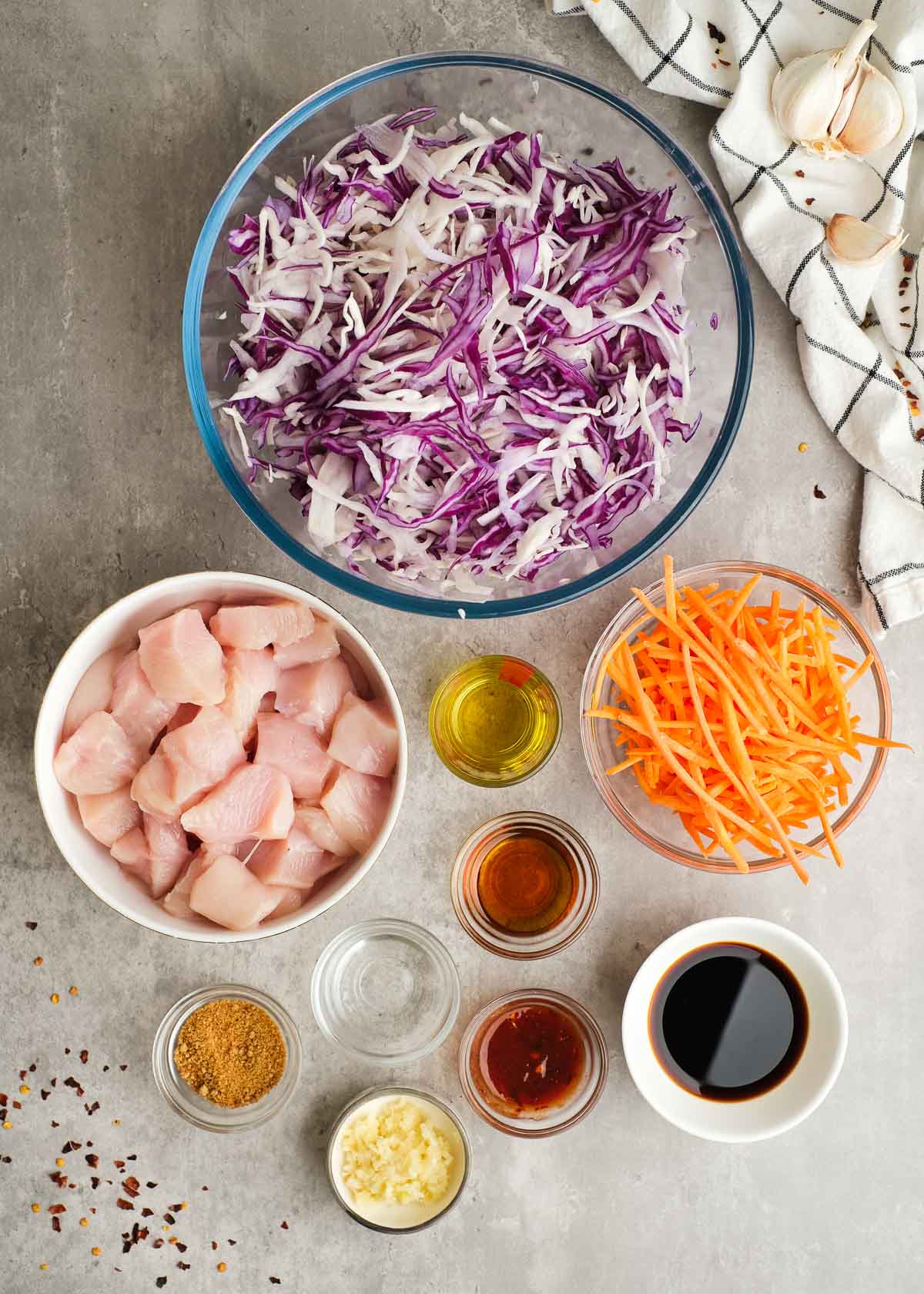 all ingredients needed for chicken egg roll in a bowl in small bowls on the counter