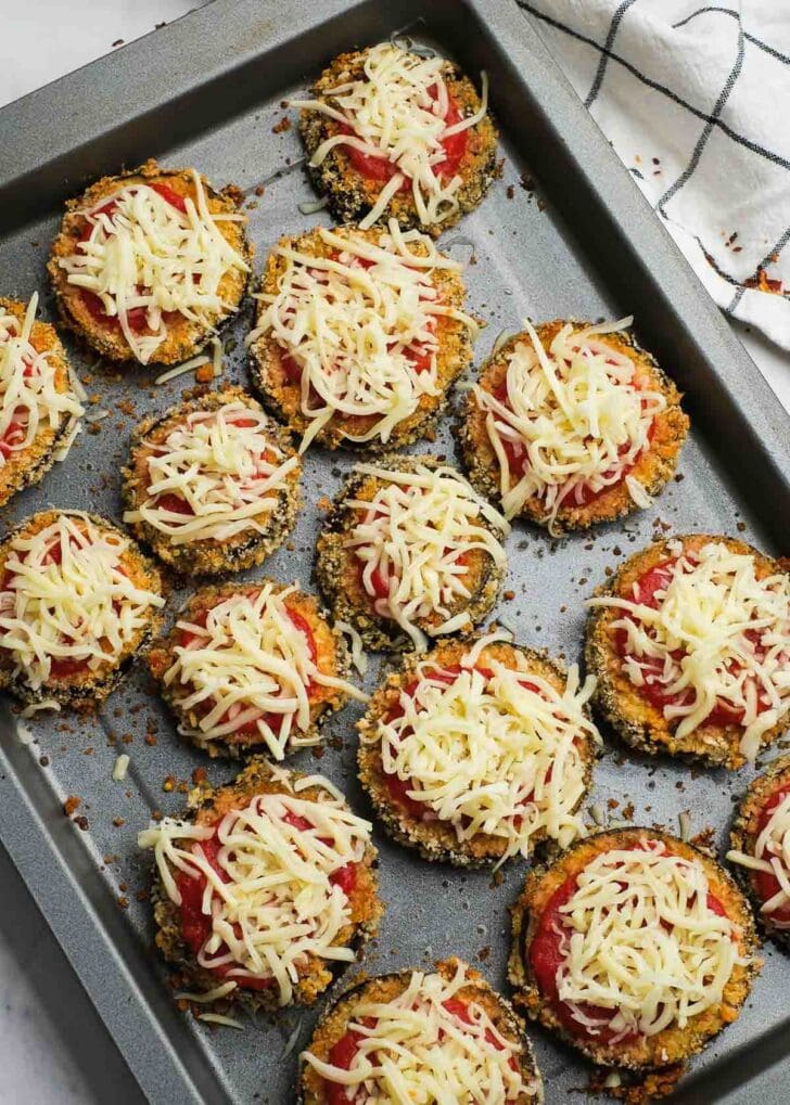 crispy eggplant bites topped with marinara sauce and shredded mozzarella cheese