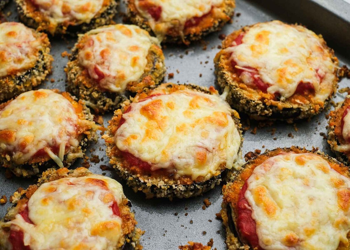 Cheesy eggplant parmesan bites on a baking pan