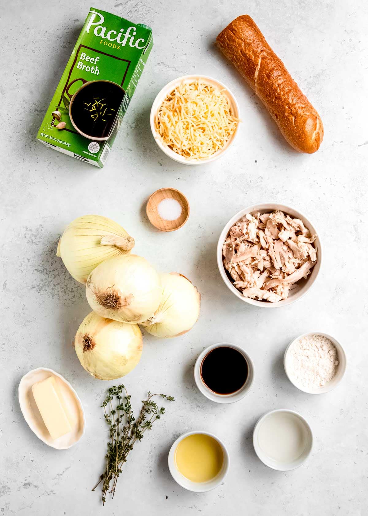 all ingredients needed for french onion chicken soup on a white countertop