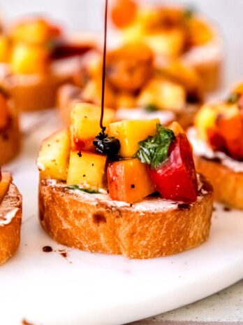 sweet balsamic reduction drizzled over a peach and tomato bruschetta