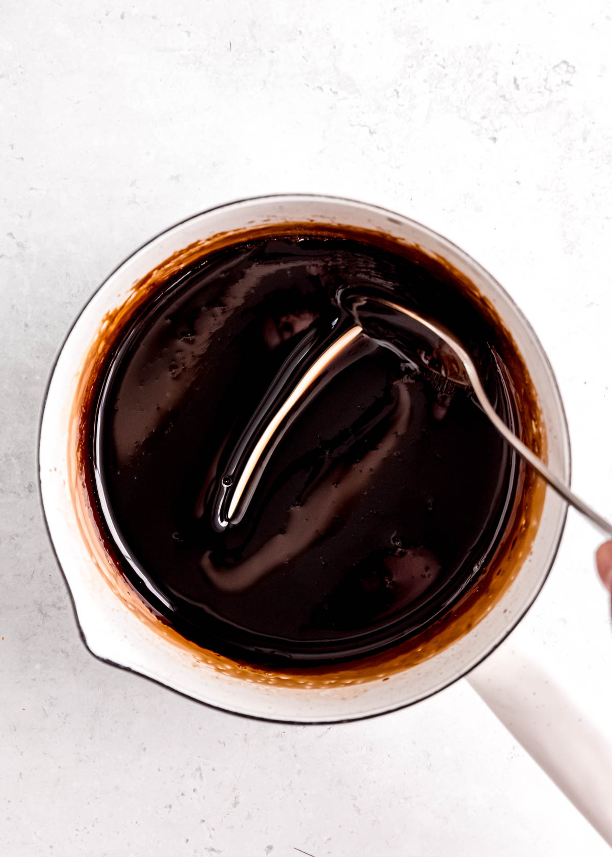 thick balsamic reduction in a white pot