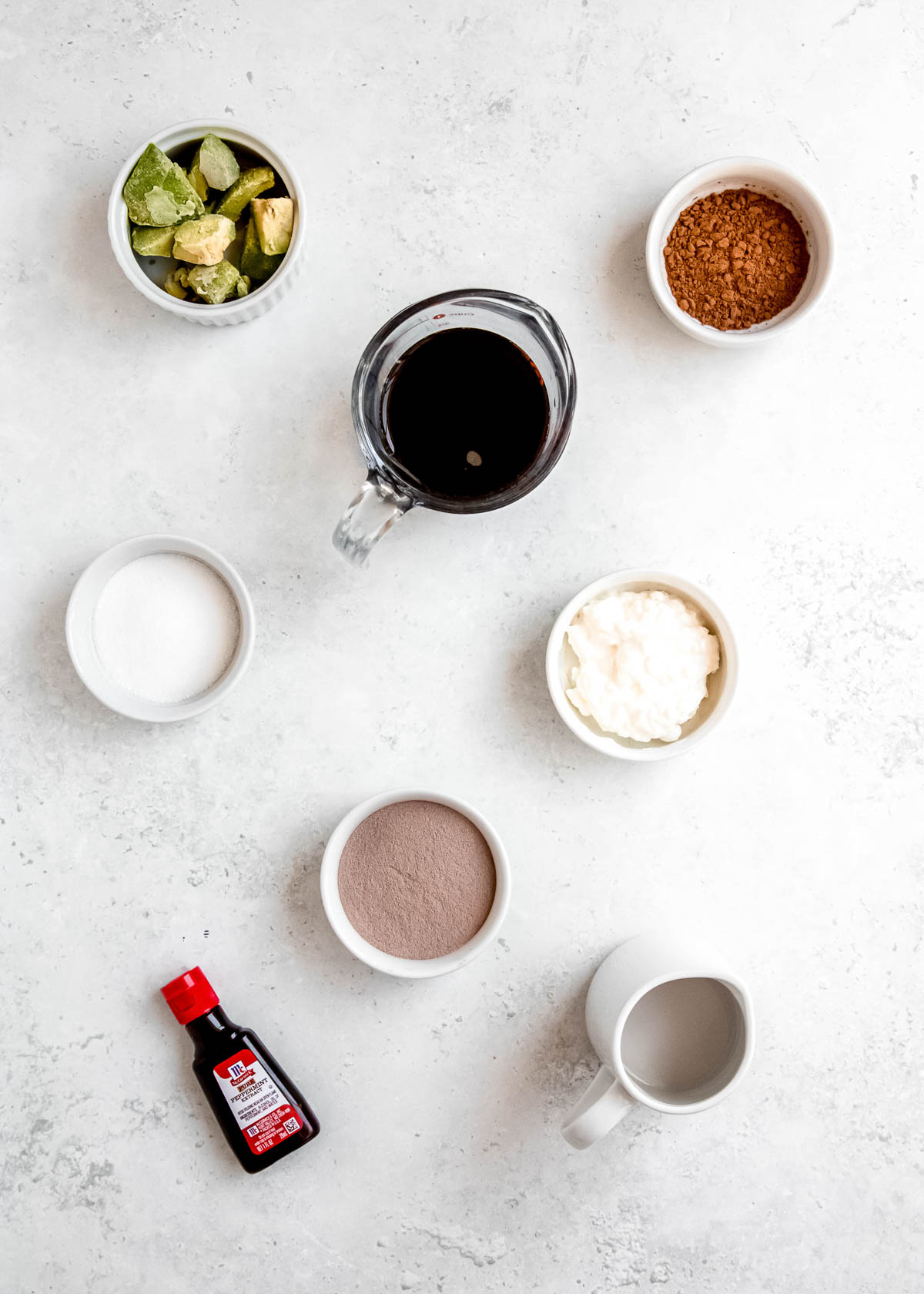 all ingredients needed for a keto peppermint mocha protein shake on a white counter