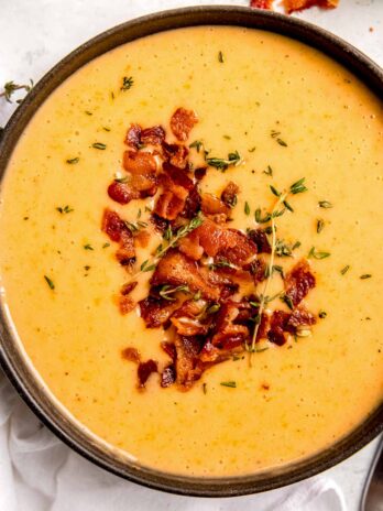 a close up of creamy potato soup with bacon