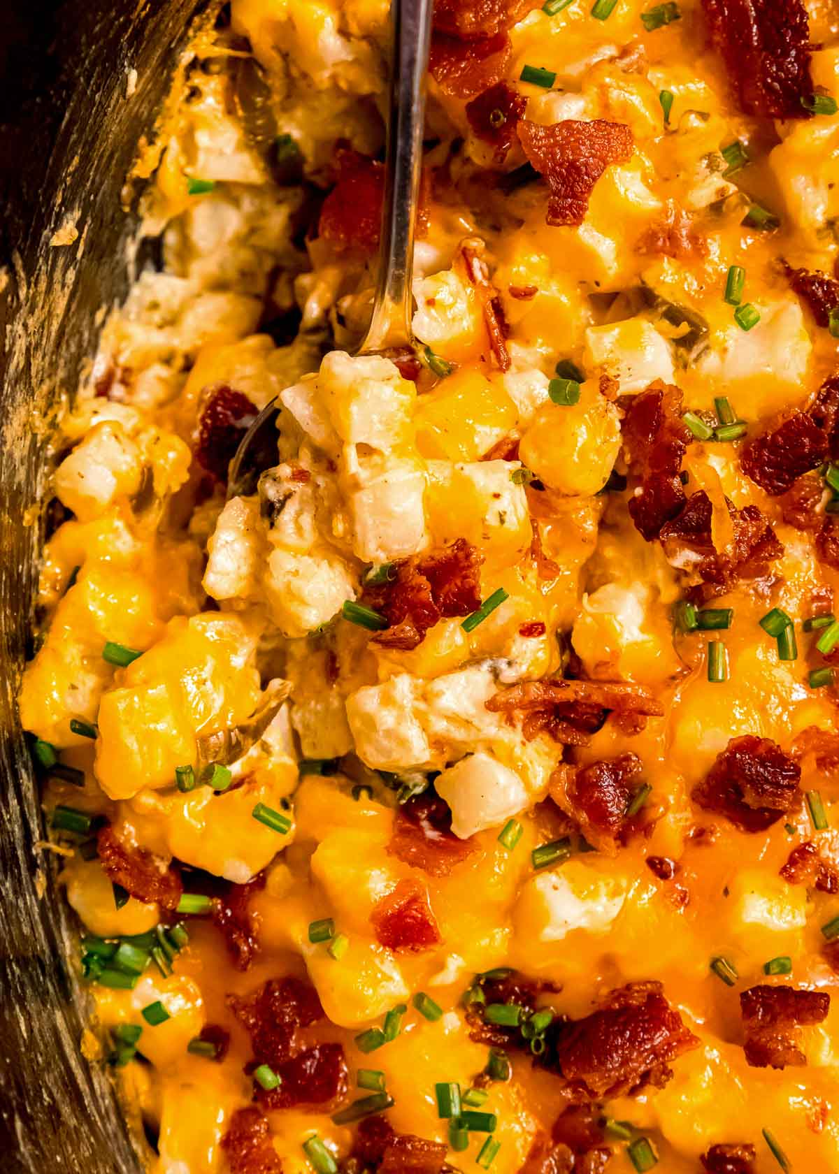 a finished image of cheese potatoes in a crockpot