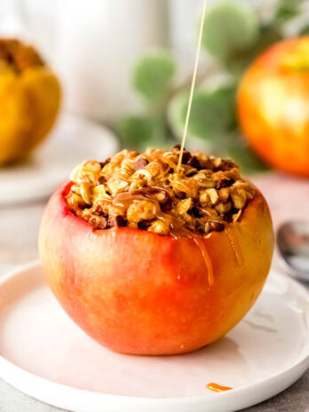 a close up shot of a stuffed baked apple with caramel drizzle