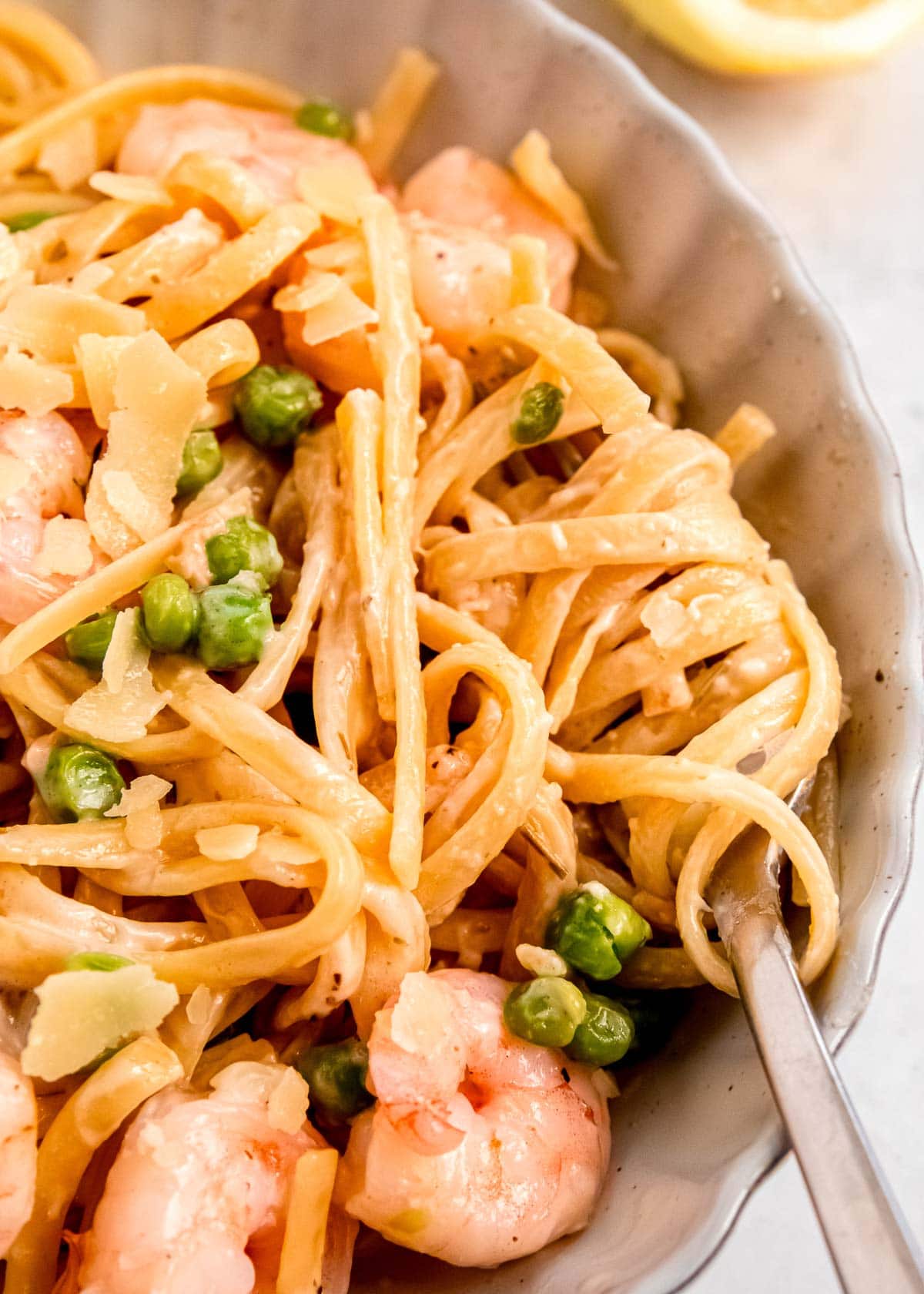 closeup shot showing the light, creamy sauce on this one pot shrimp pasta with peas