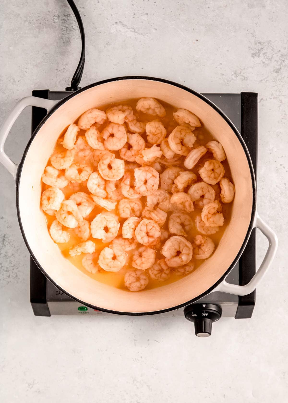 shrimp cooking in a dutch oven