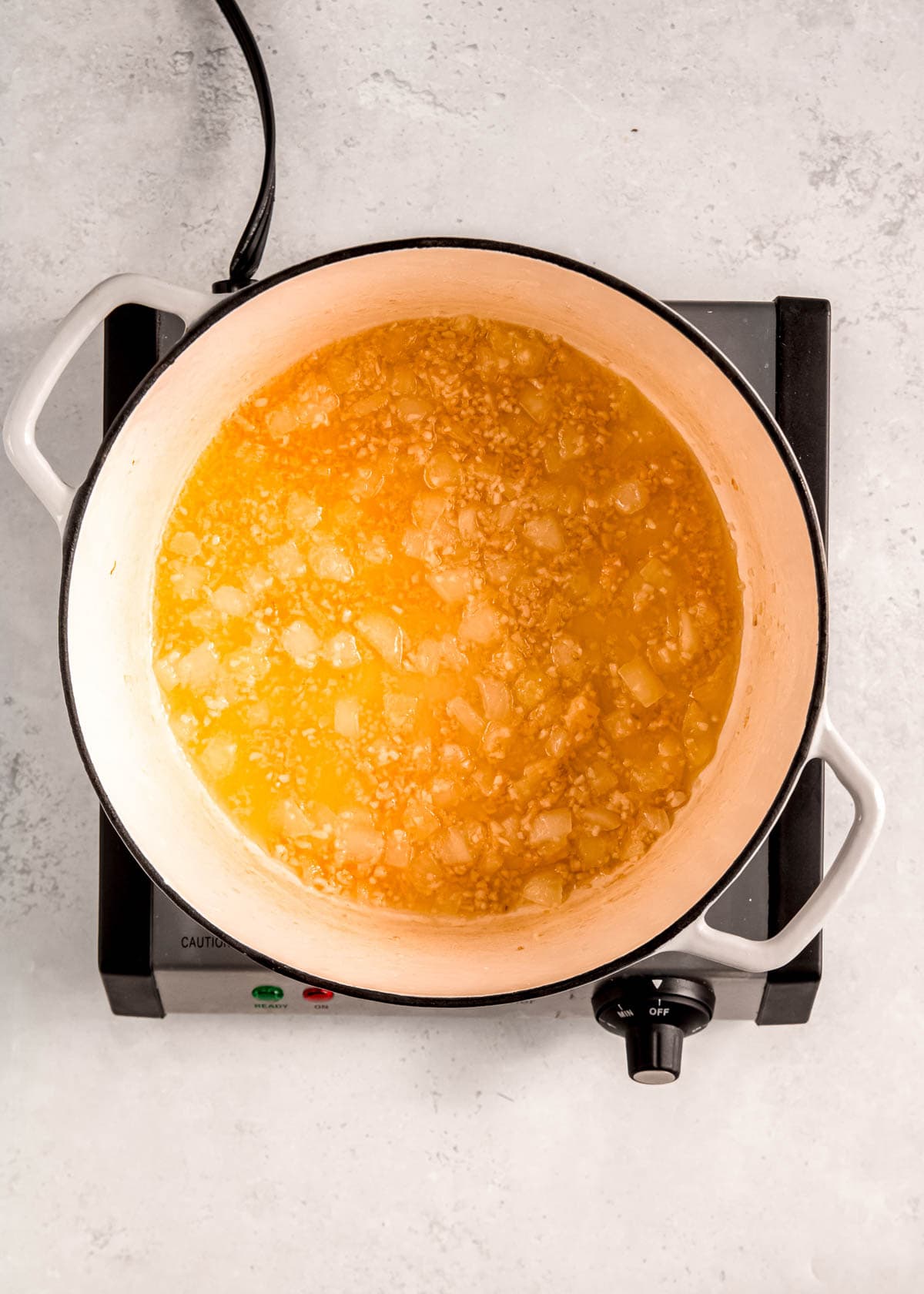 onion and garlic sauteing in butter and olive oil