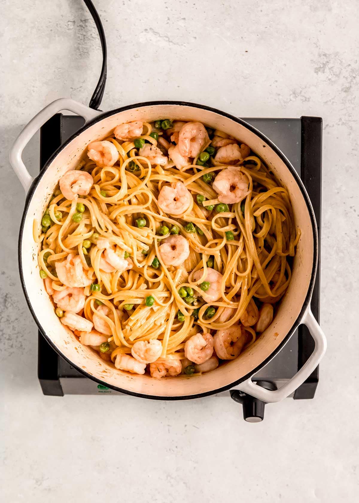 shrimp stirred in with creamy linguine and peas