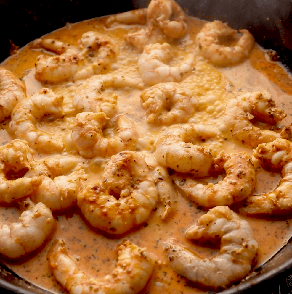 cajun shrimp in butter sauce on cast iron skillet