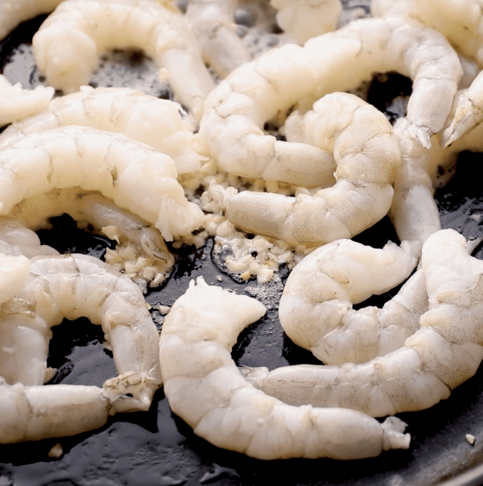 raw shrimp in cast iron skillet