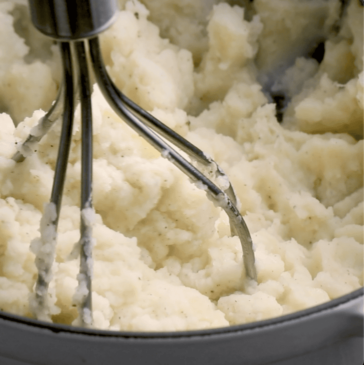 potates being mashed in bowl