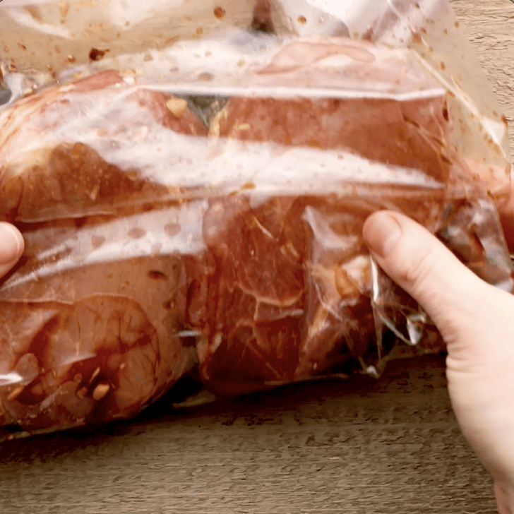 pork chops being marinaded in zip loc bag