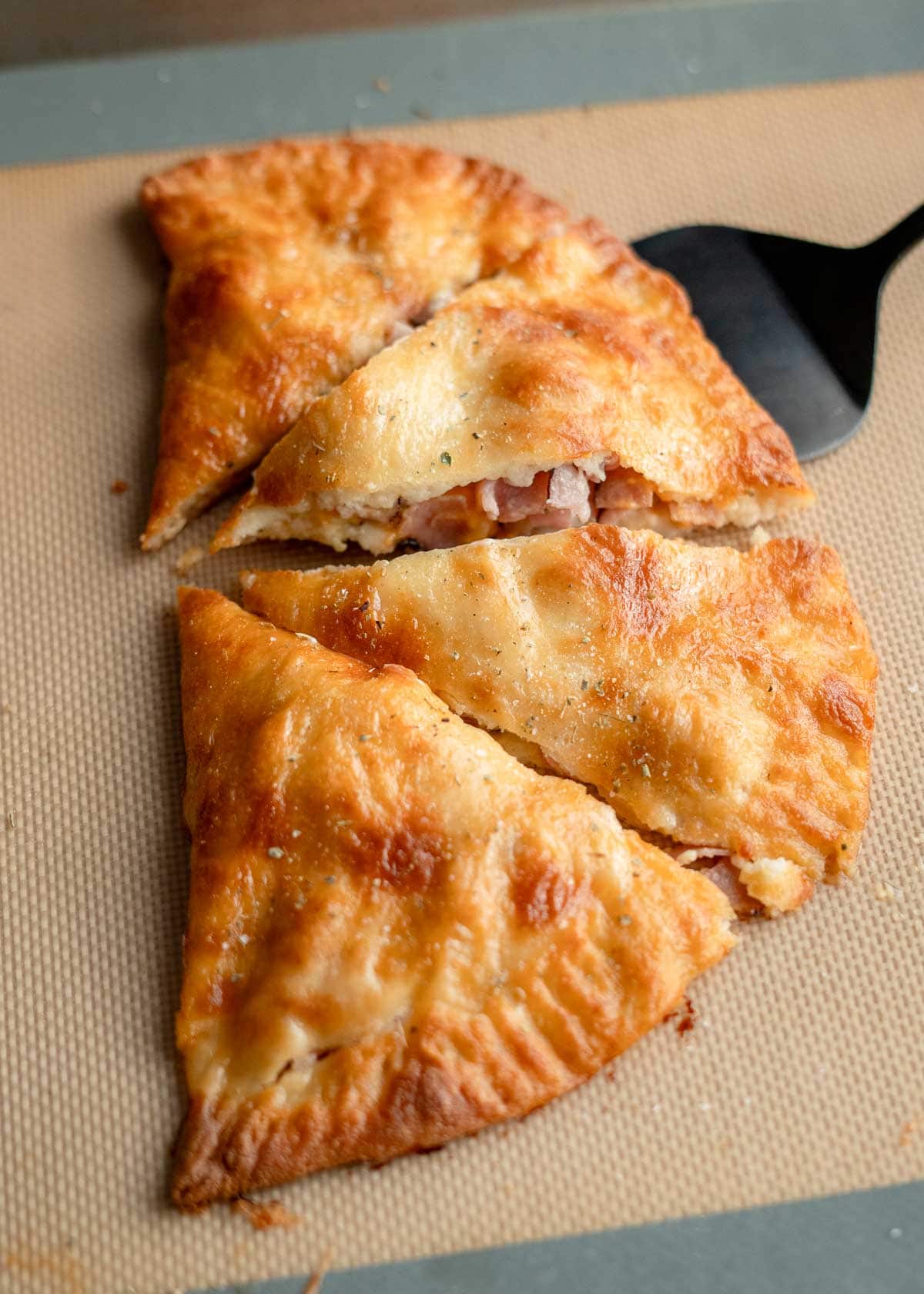 a baked ham and cheese calzone