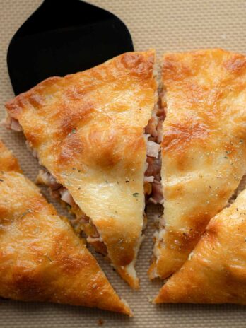 a slice of ham and cheese calzone