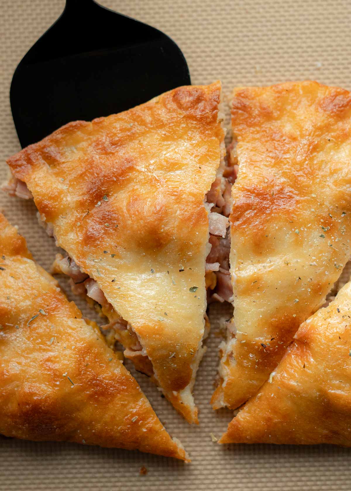 a slice of ham and cheese calzone