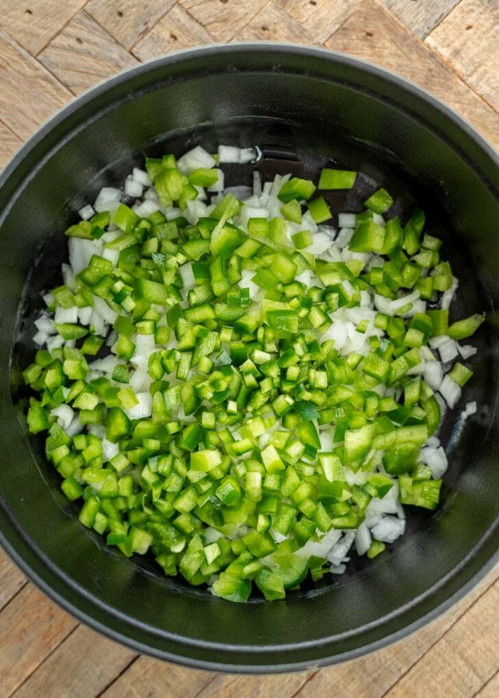 uncooked peppers and onions in dutch oven