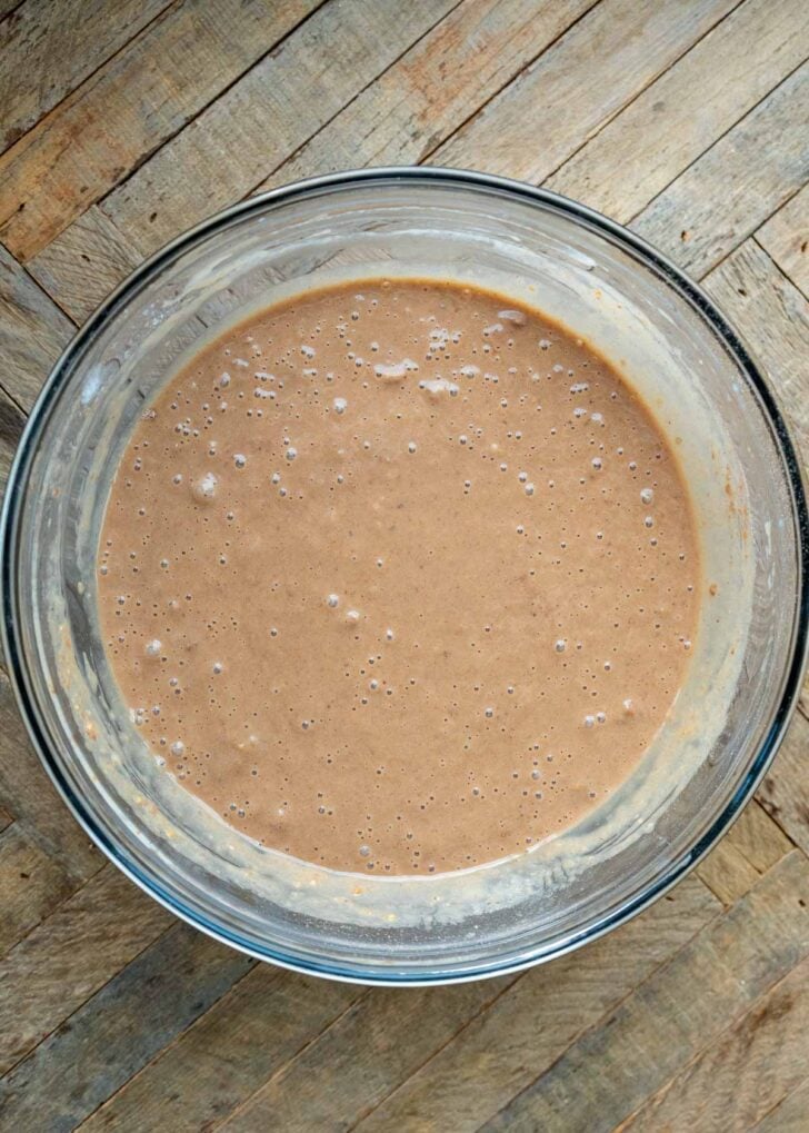 smooth peanut butter banana protein waffle batter in a glass bowl