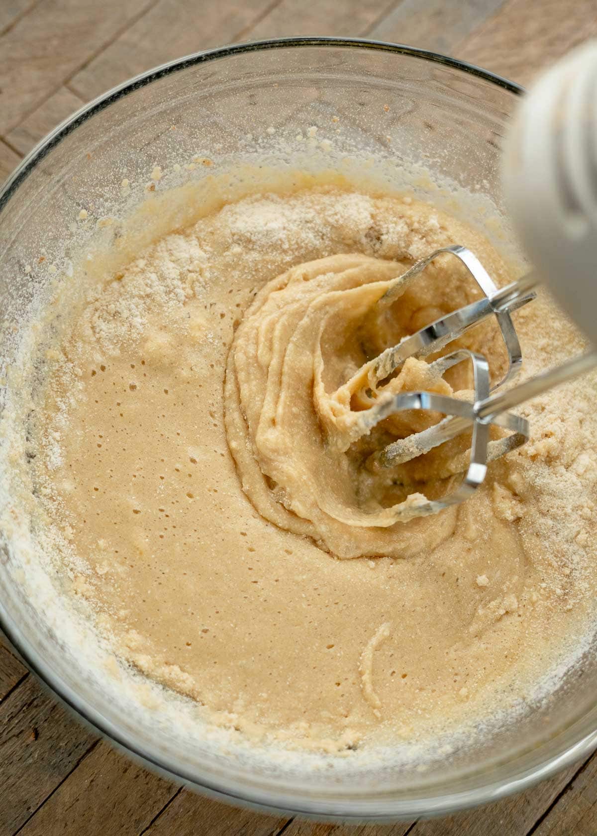 coconut flour muffin batter being mixed with an electric mixer