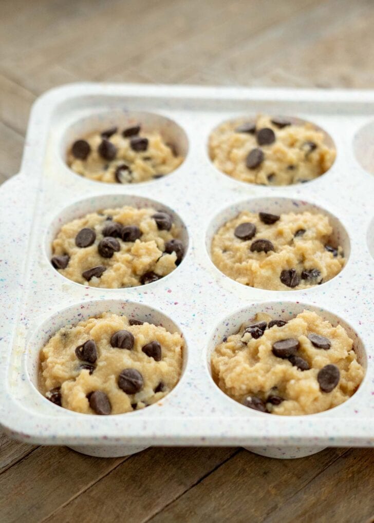 coconut flour muffin batter spooned into a silicone muffin pan